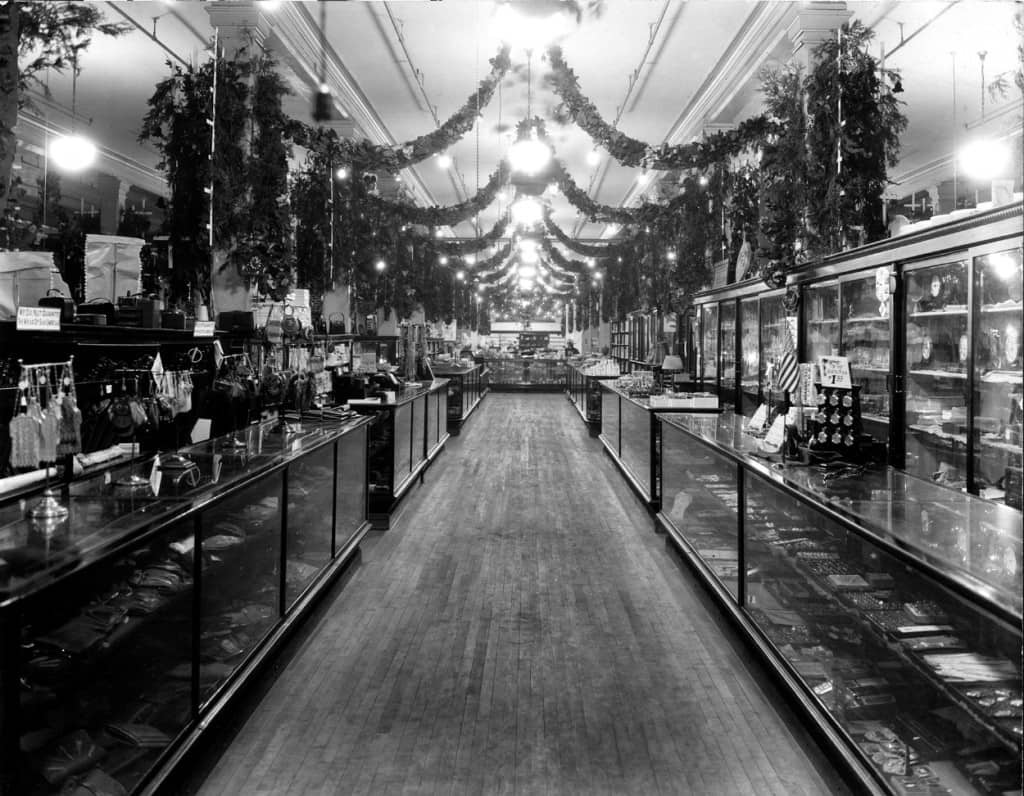 Wide aisles, high ceilings, and glass show cases such as these at Lauermans of Marinette were common in the glory days of the department store. This is the jewelry and accessories department of Lauermans, circa 1920. A marble floor was added in 1935. Author's collection.