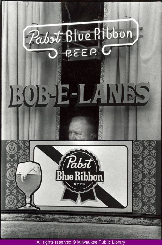 A man peers out a window at Milwaukee's Bob-E-Lanes bowling alley and tavern.