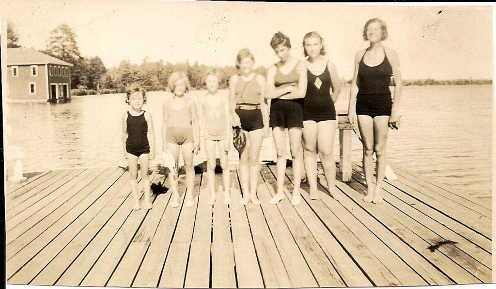 Girls standing on pier, Three Lakes, 1937