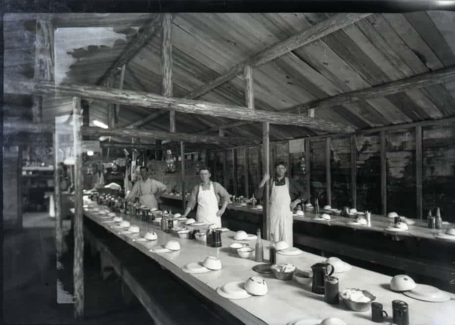 Tables set in the mess hall before loggers descend. Photo by Arthur J. Kingsbury. Langlade County Historical Society.