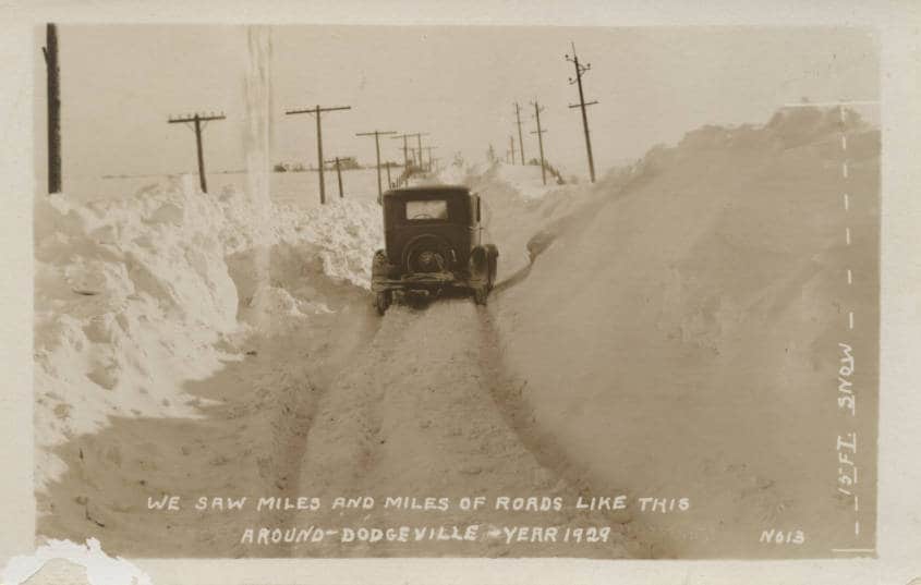 "We saw miles and miles of roads like this around Dodgeville." The caption along the right edge of this postcard notes a 15-foot snowdrift. Iowa County Historical Society.