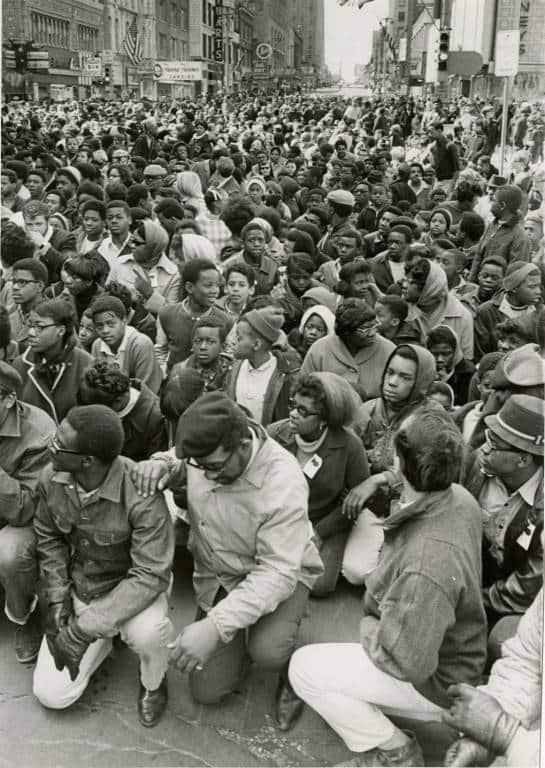 A large crowd kneels in prayer on Wisconsin Avenue in Milwaukee on the first anniversary of the assassination of Dr. Martin Luther King, Jr., May 5, 1969. Photo from the Milwaukee Journal. Milwaukee Public Library.