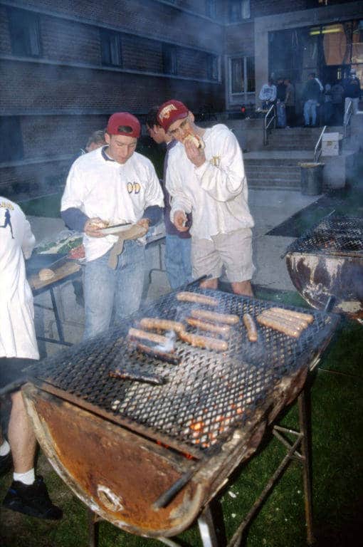 Grilling brats outside O'Donnell Hall, Marquette University, 1994. Building a Campus, Department of Special Collections and University Archives, Marquette University Libraries.