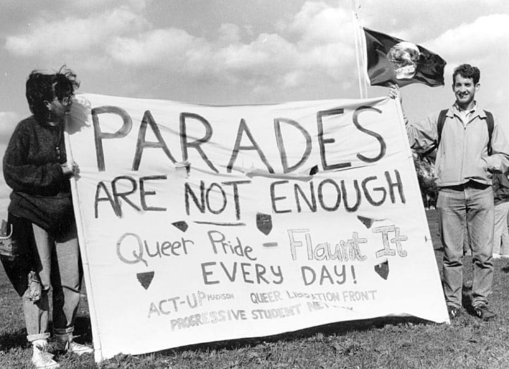 Students at a gay pride rally with a banner reading “Queer Pride-Flaunt It,” University of Wisconsin-Madison, probably 1990s. UW-Madison Archives by way of University of Wisconsin Digital Collections.