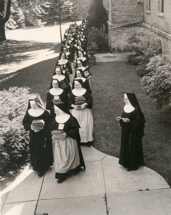 Transferring books from Holy Family Convent to Holy Family College, Manitowoc, Wisconsin, 1960. Silver Lake College.