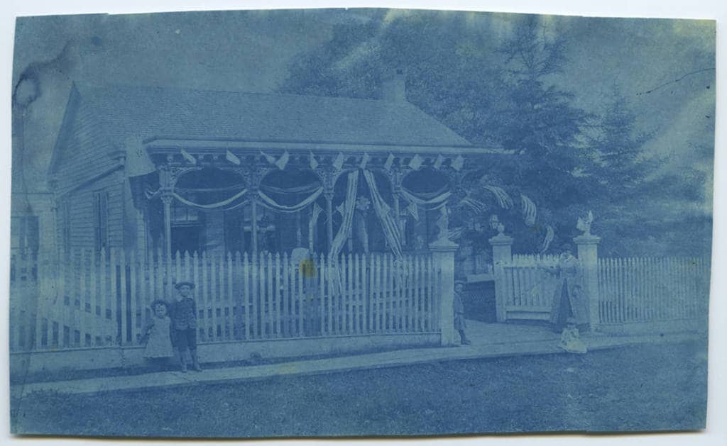 Cyanotype of 510 Church street, decorated with flags and bunting. Mineral Point Library Archives.