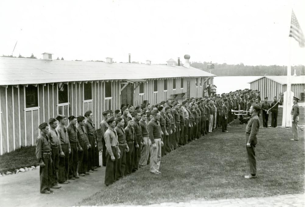 Morning reveille at Camp 657. CCC camps operated like the military, with U.S. Army officers in command under the aegis of the Departments of Labor, Interior, and Agriculture. Photo by Warren Schabell. Langlade County Historical Society.