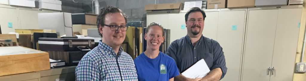 Cameron Fontaine, Amy Meyer and mentor Pete Shrake (Circus World Museum) in collections storage at the Manitowoc County Historical Society.