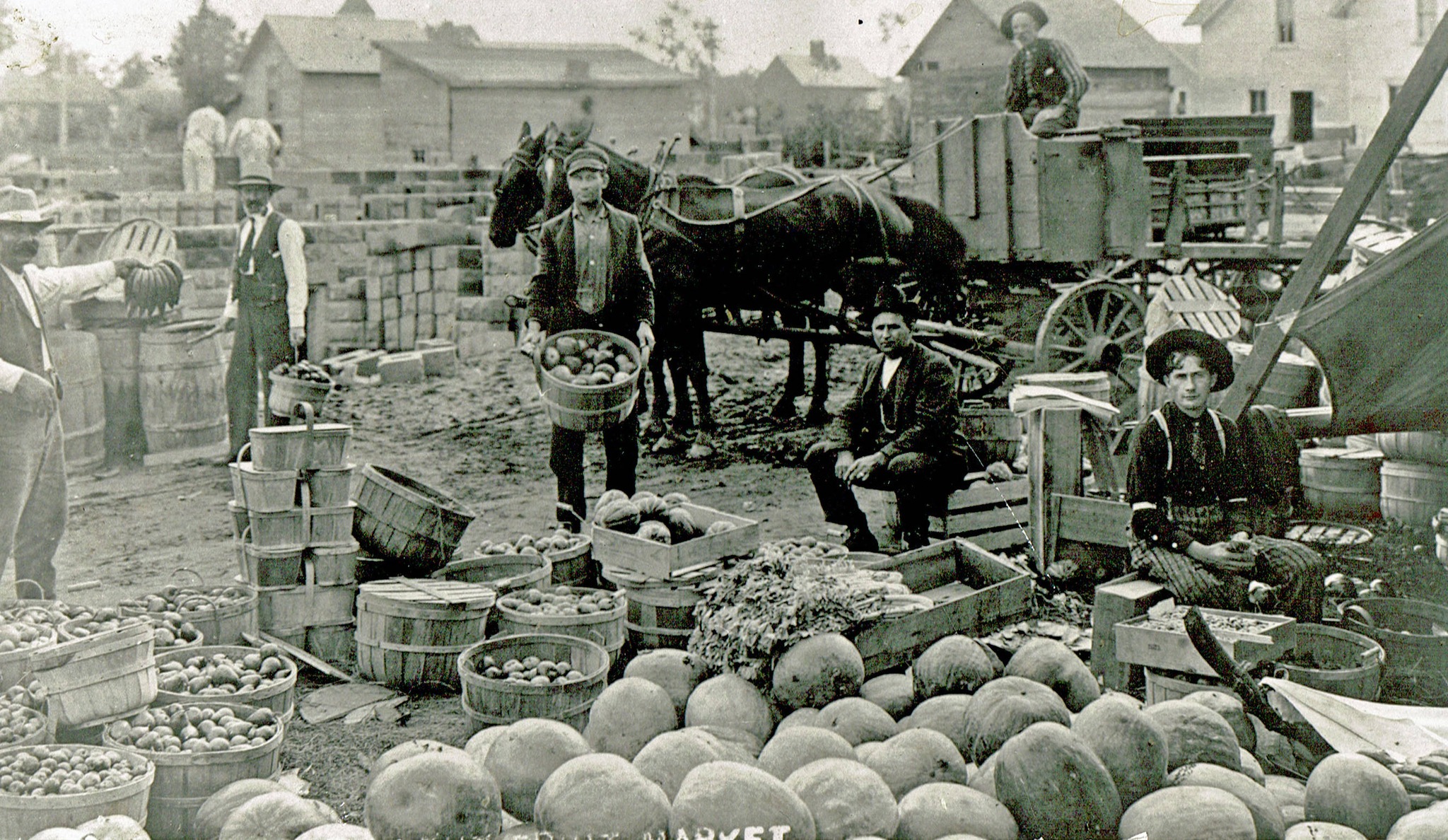 A farmer’s market in progress behind the Opera House on the South side of Washington Street. ca. 1900-1910.