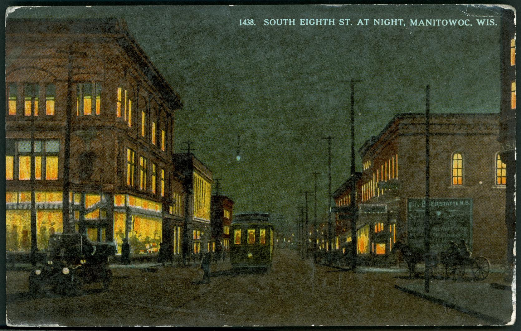 South Eighth Street at night looking to the north from just south of Jay Street. Schuette Brothers is on the left and Buerstatte drugstore on the right. ca. 1921-1927.