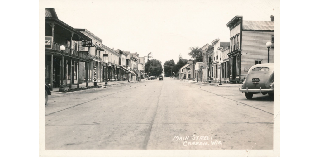 Main Street, Cambria, Wis. postcard 2, ca. 1935. Street view showing main street buildings. 