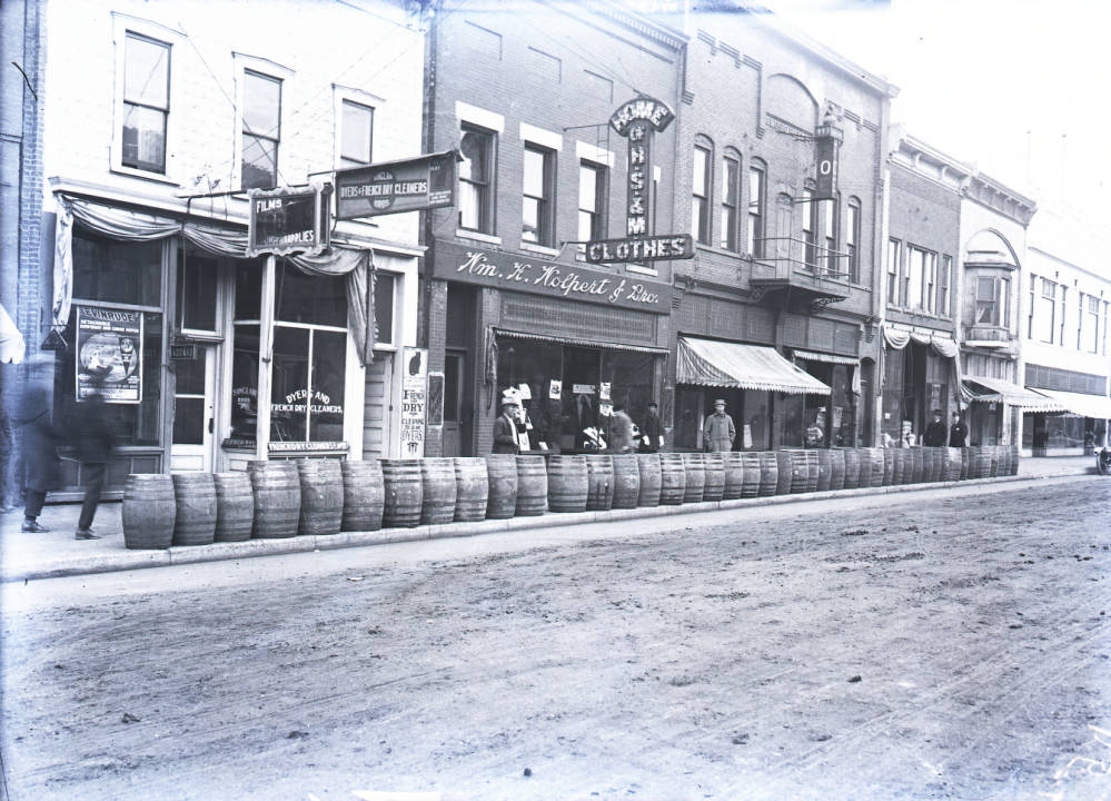 Street scene showing several businesses including Wolpert clothing store.