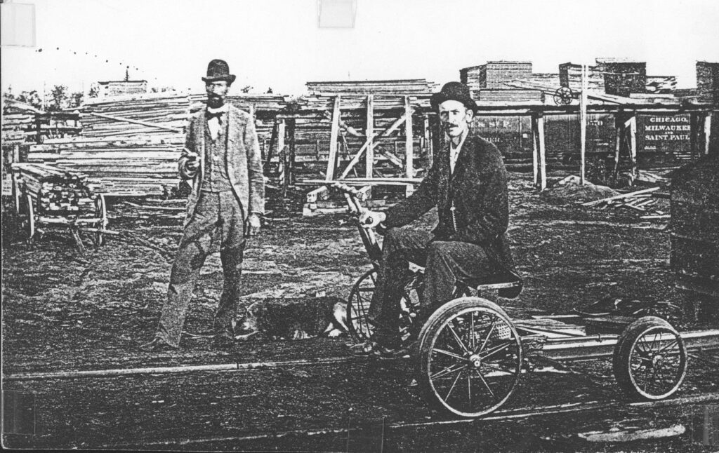 An employee rides a velocipede in the CM&StP yards at Merrill.