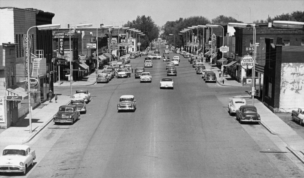 Depicts Main Street of New Richmond, including downtown businesses and automobiles. May 1957.