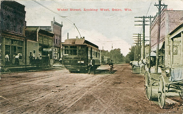 A view looking down Water Street (now Main Street). The interurban car visible at center carried Omro citizens to Oshkosh, ca. 1912.