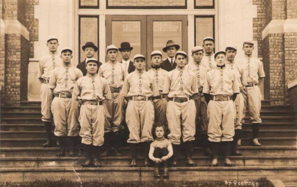 This is a good sentence and photo. Postcard of the Western Wisconsin Championship Baseball team, sponsored by the Onalaska Pickle and Canning Company (OPACCO).