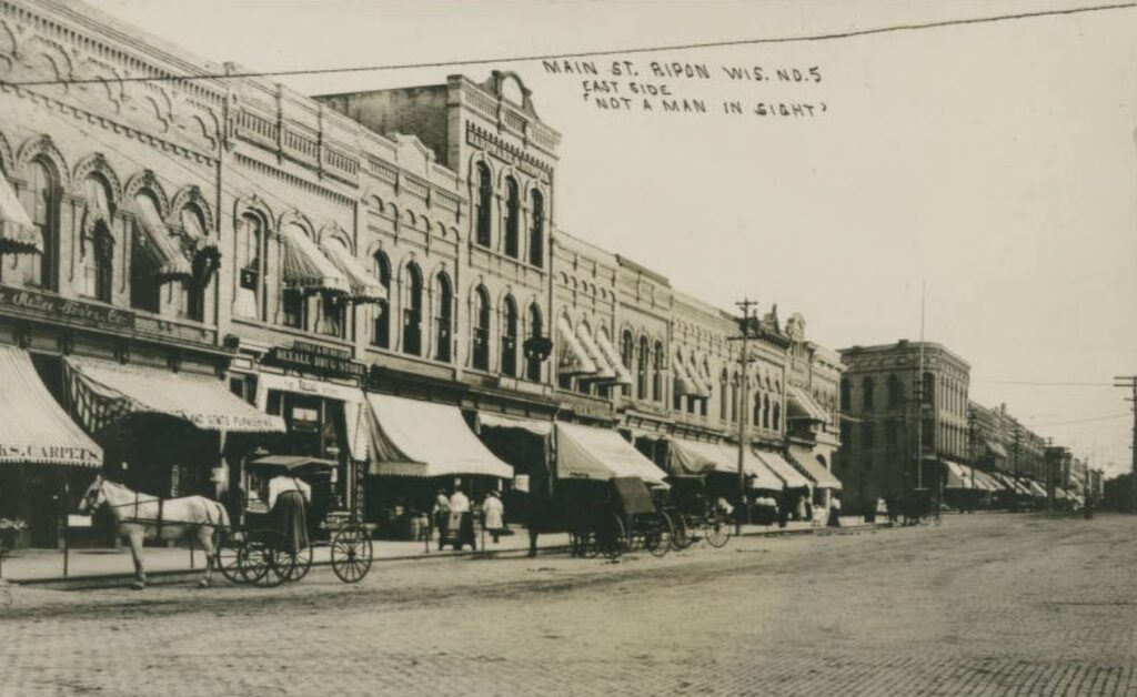 Main Street, ca. 1909, with caption "Not a Man in Sight."