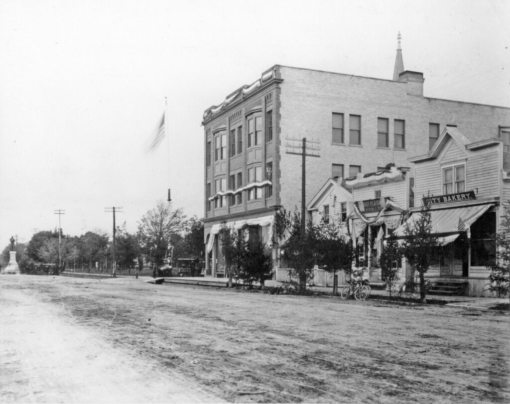 Photograph dated June 9, 1900, and taken a few hours after the unveiling ceremonies for the Soldiers Monument (visible at the far left of the image). The east side of Washington Street at 17th Street includes Schroeder Brothers Company, which had just moved into the corner building, as well as the Stollberg home, Stollberg Tavern and City Bakery.